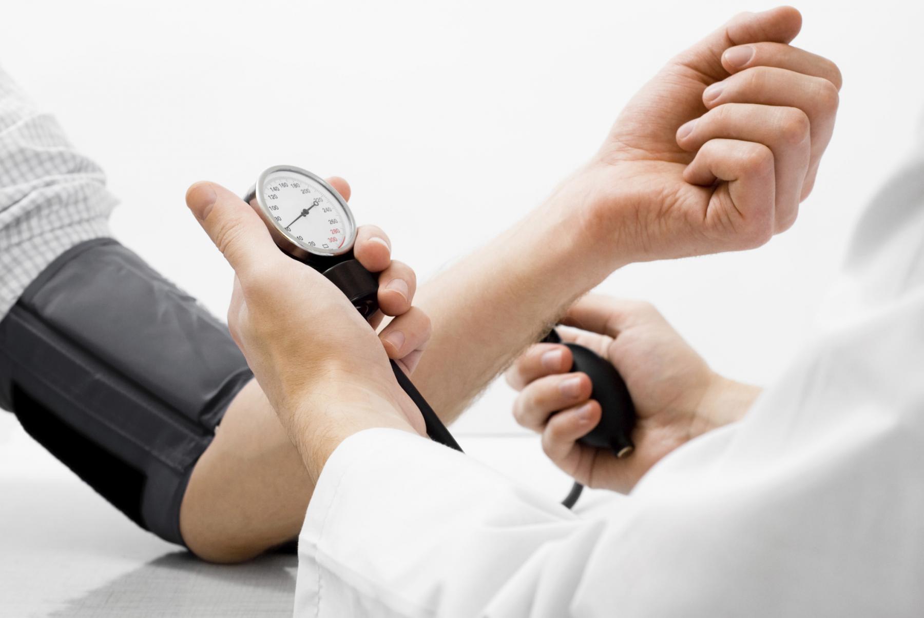 doctor checking patients blood pressure