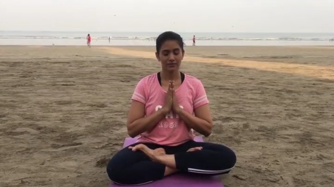 Bollywood and Marathi film actor Sonali Kulkarni performs yoga at the beach
